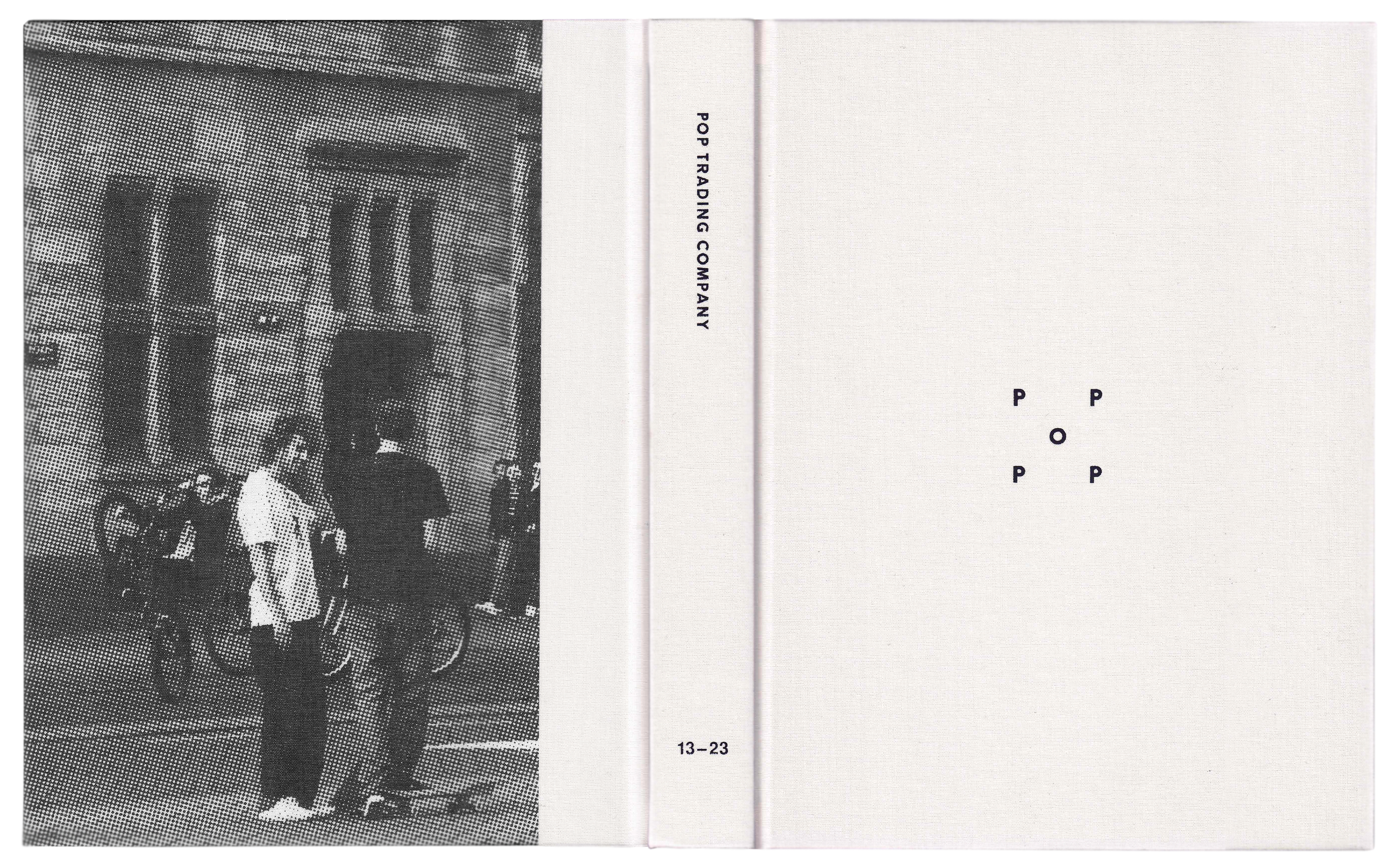 Scan of a book with a black and white image of two skaters on the street